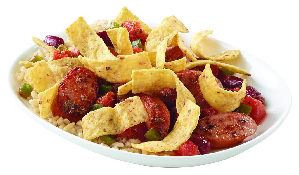 White bowl containing brown rice, peppers, beans, sausage and corn chips