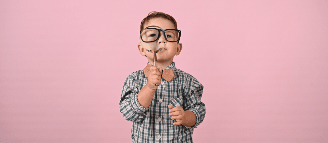 Child looking toward you through magnifying