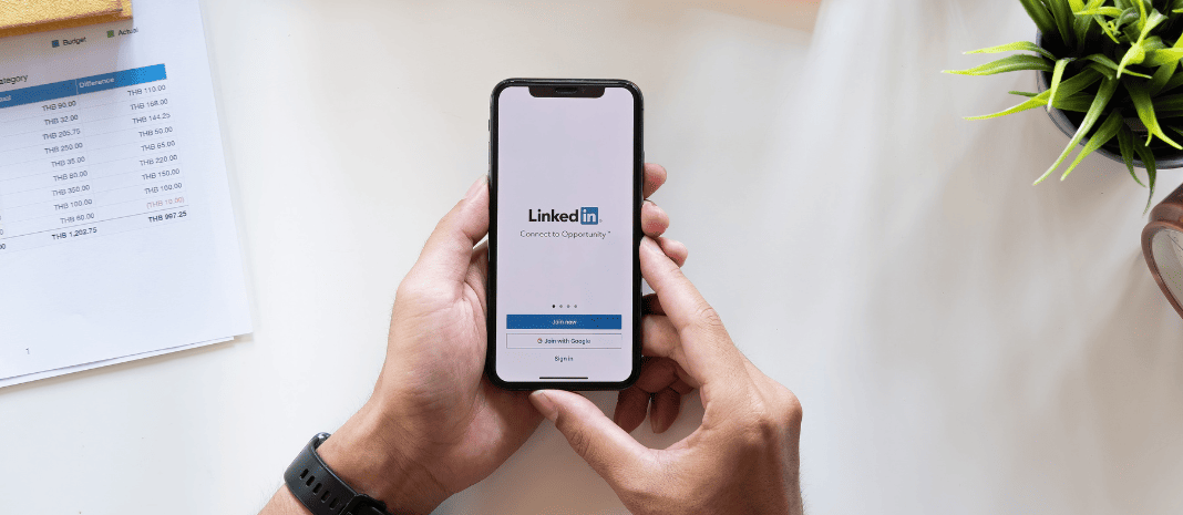 Person holding a phone with the LinkedIn app open